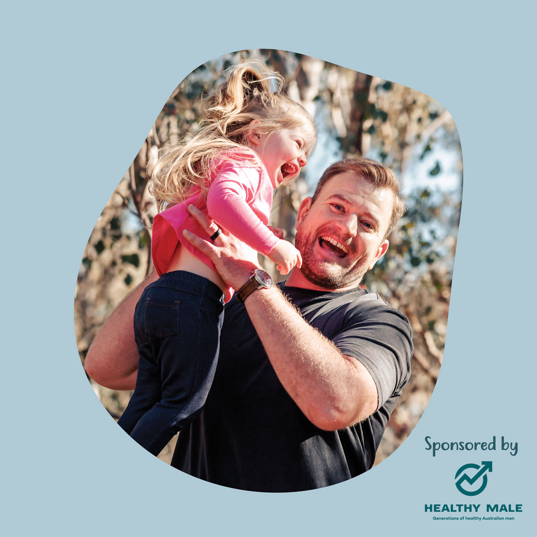 Arran smiles as he holds his giggling daughter over his head.