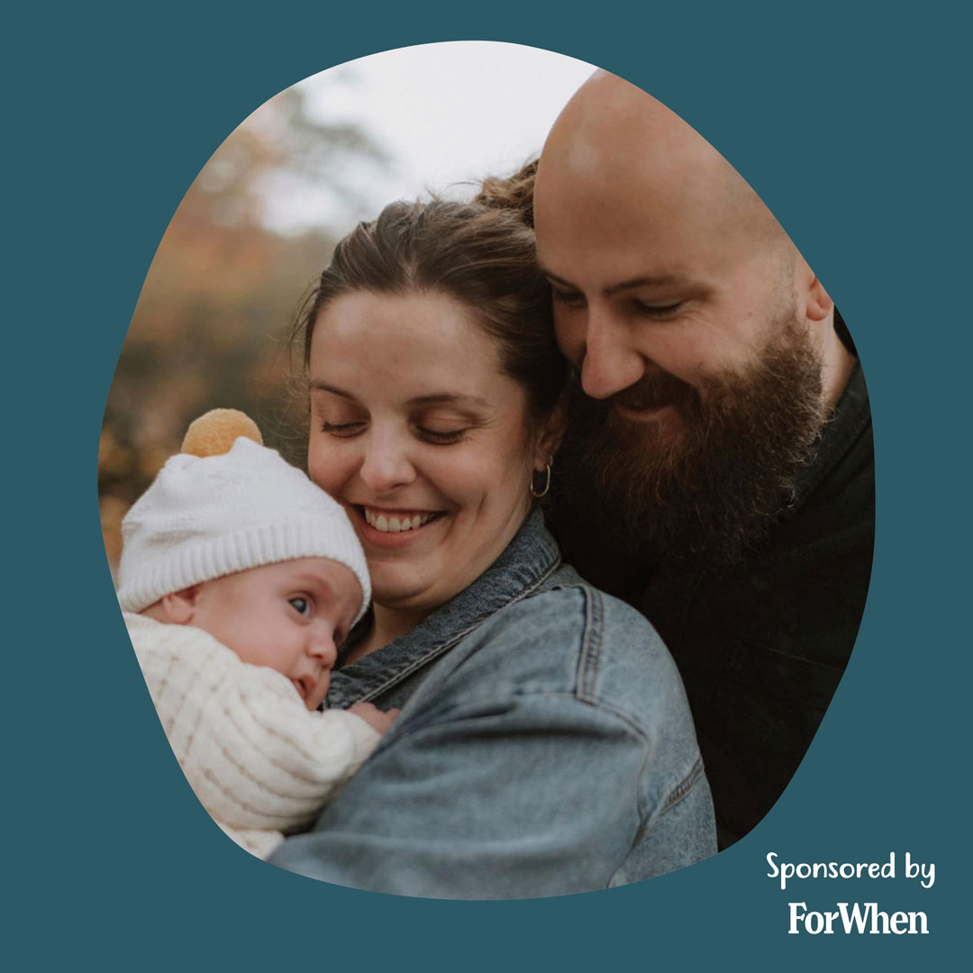 Lauchlan and his partner smile as they hold their baby daughter.