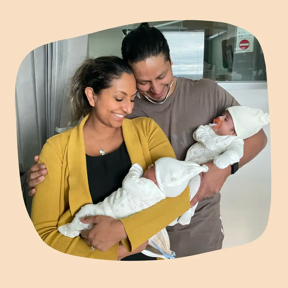 Laura poses for a photo with her husband and two children.