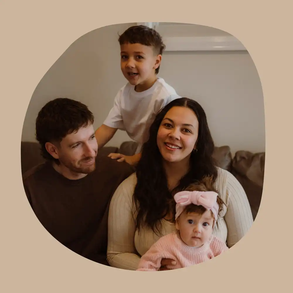 Laura poses for a photo with her husband and two children.