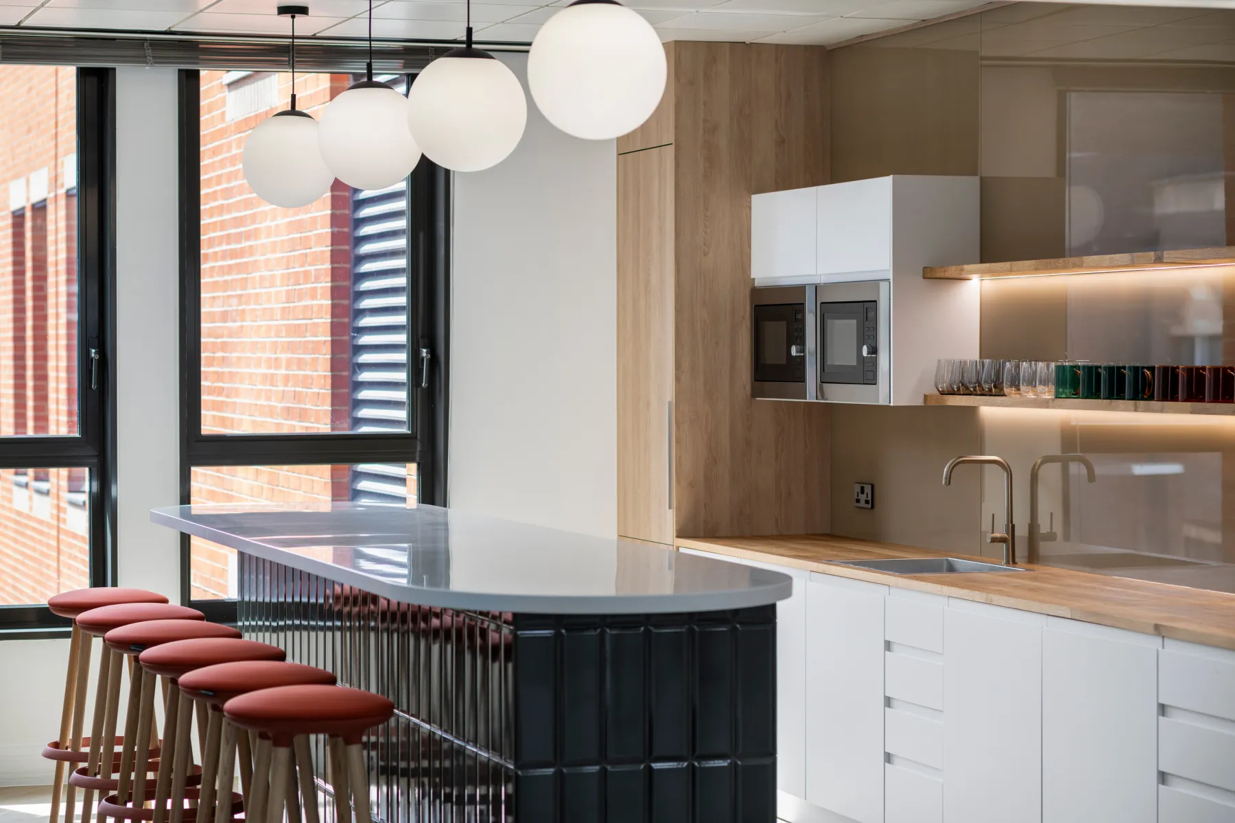 A sleek and modern kitchen area designed for Aquis House