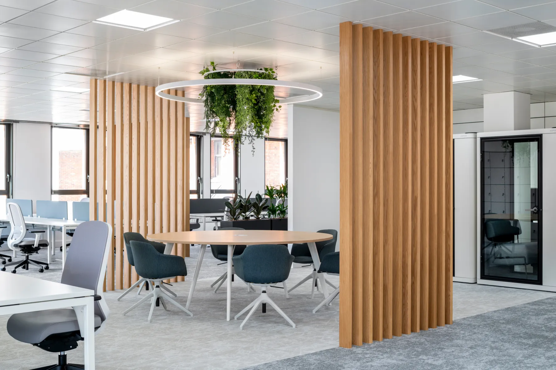 A modern office with wood panelling and modern ceiling lighting