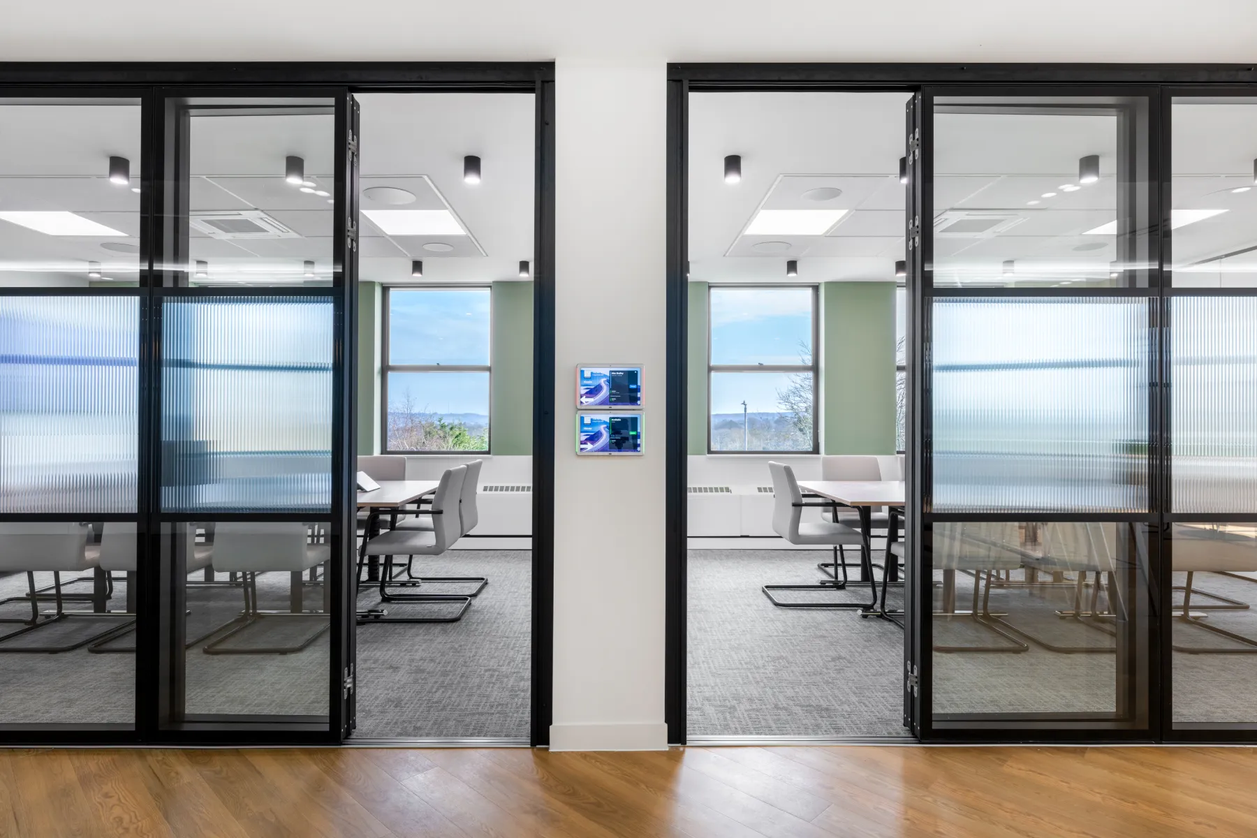 Two separate offices with glass doors and black frames at Birketts in Sevenoaks