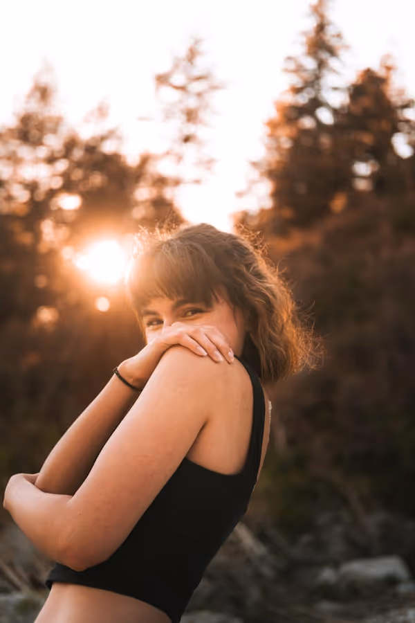 a woman in a black top is posing for a picture