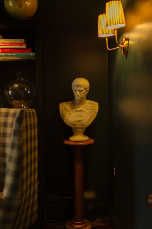 decorative bust of David in the cozy library room at The Federal Inn in Maumee Ohio