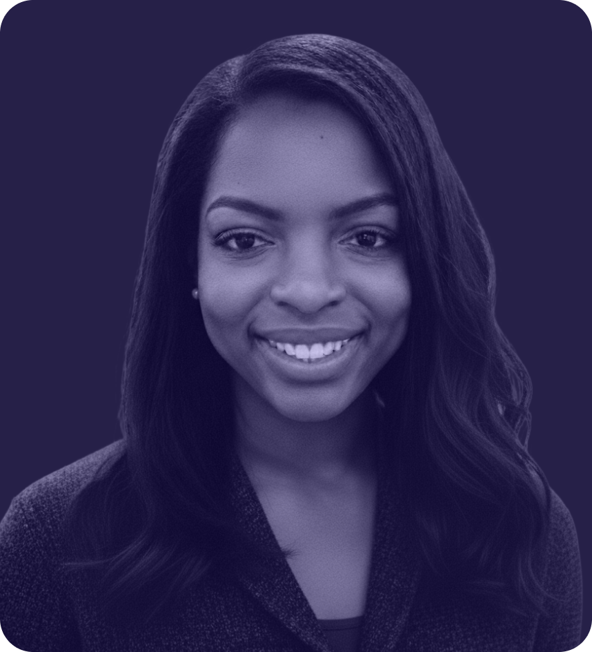 Portrait of a smiling woman with long hair wearing a dark textured blazer.