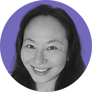 Close-up portrait of a smiling woman with long dark hair against a purple circular background.