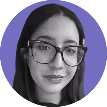 Black and white close-up portrait of a woman with long dark hair wearing large glasses against a solid purple circular background.