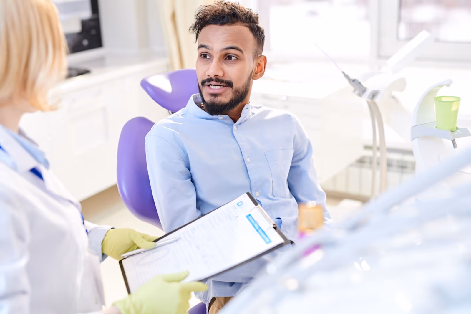 treatment coordinator speaks with a dental patient