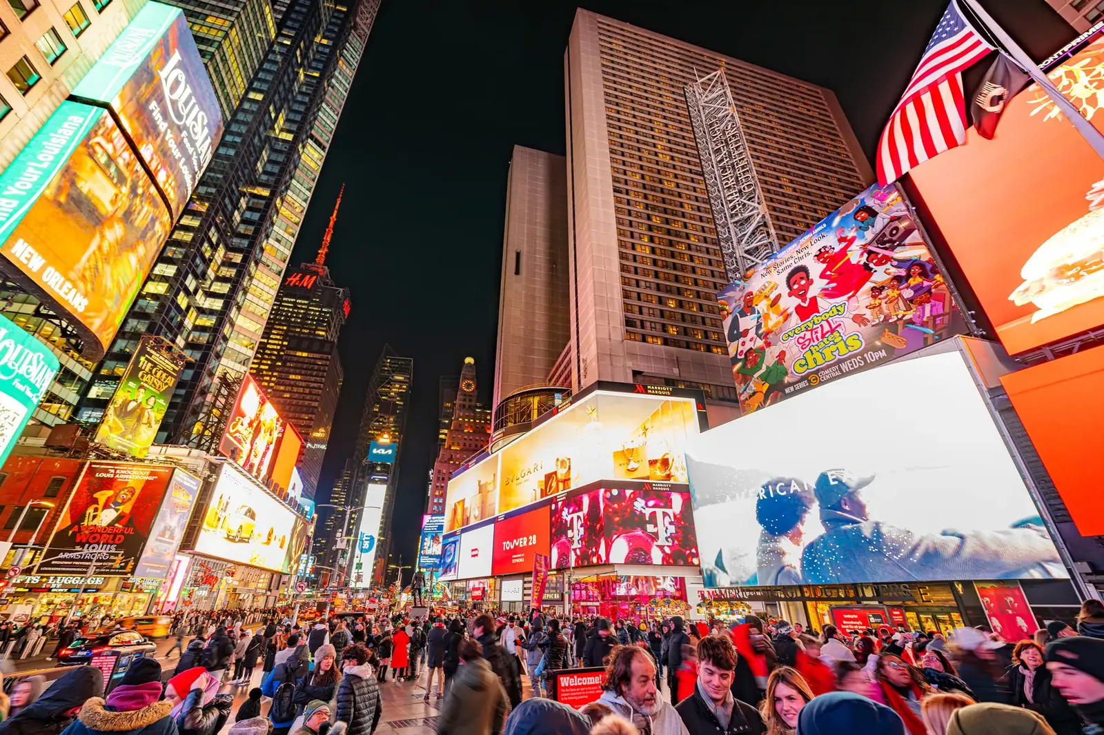 Times Square in New York City at night with illuminated billboards and crowds
