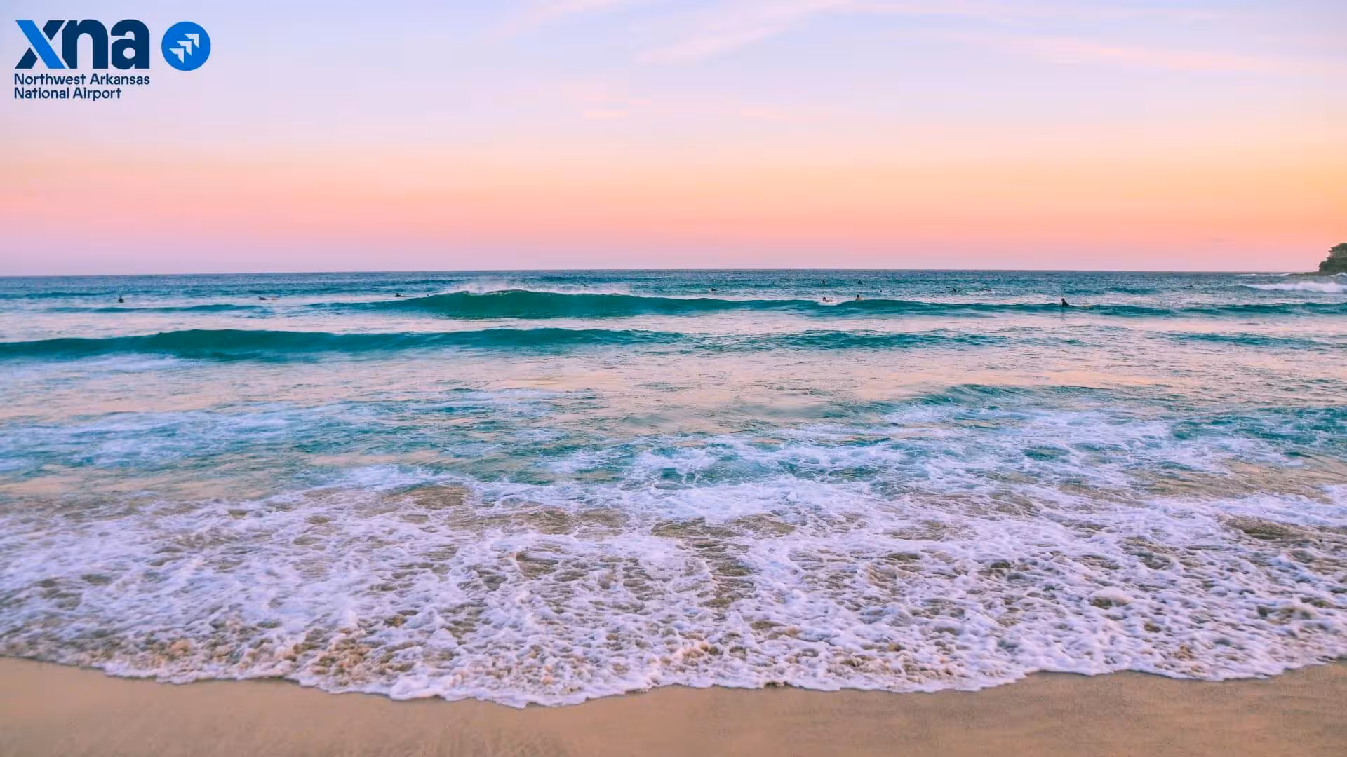 Waves crashing on a beach in the sunset