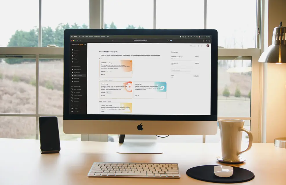 RevenueJack project dashboard displayed on an iMac in a modern workspace