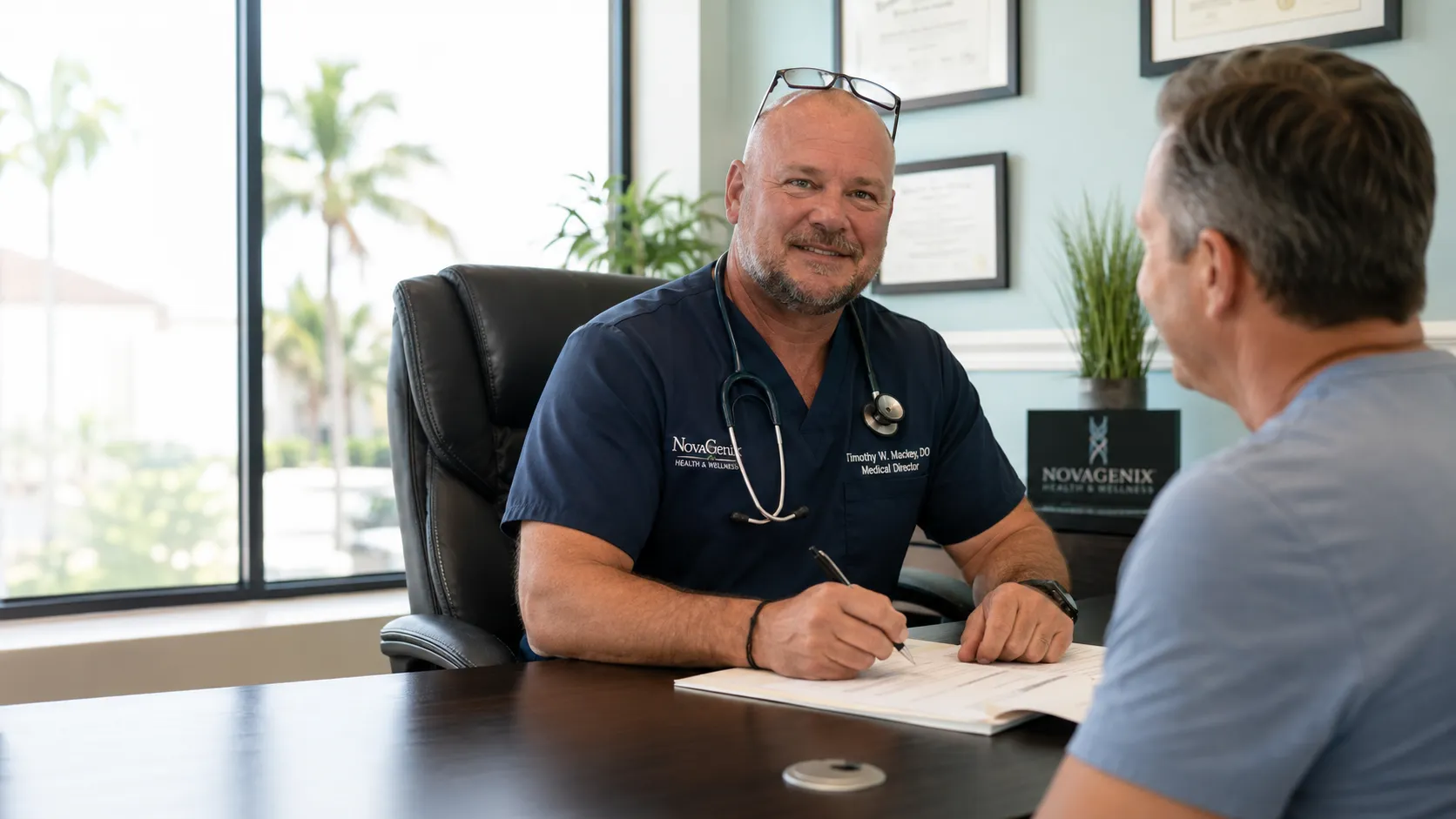Dr. Timothy W. Mackey consulting with a patient at NovaGenix in Jupiter, Florida.