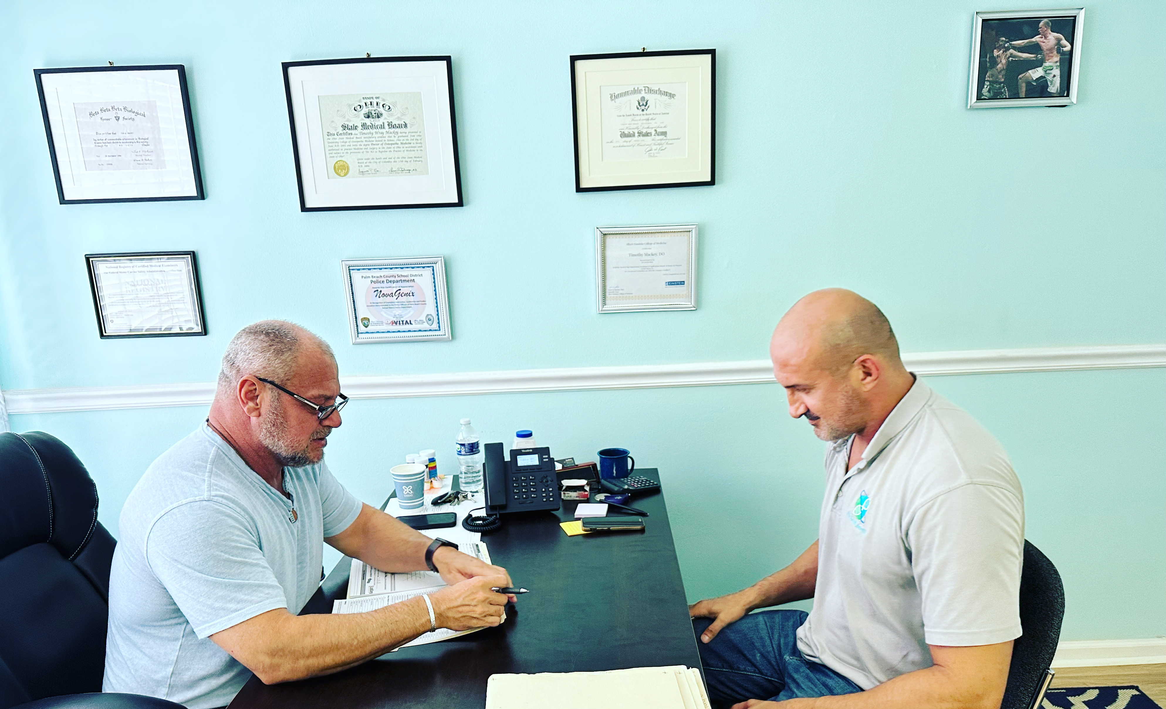Dr. Mackey reviwing patient labs with clinic manager Andy at NovaGenix Office