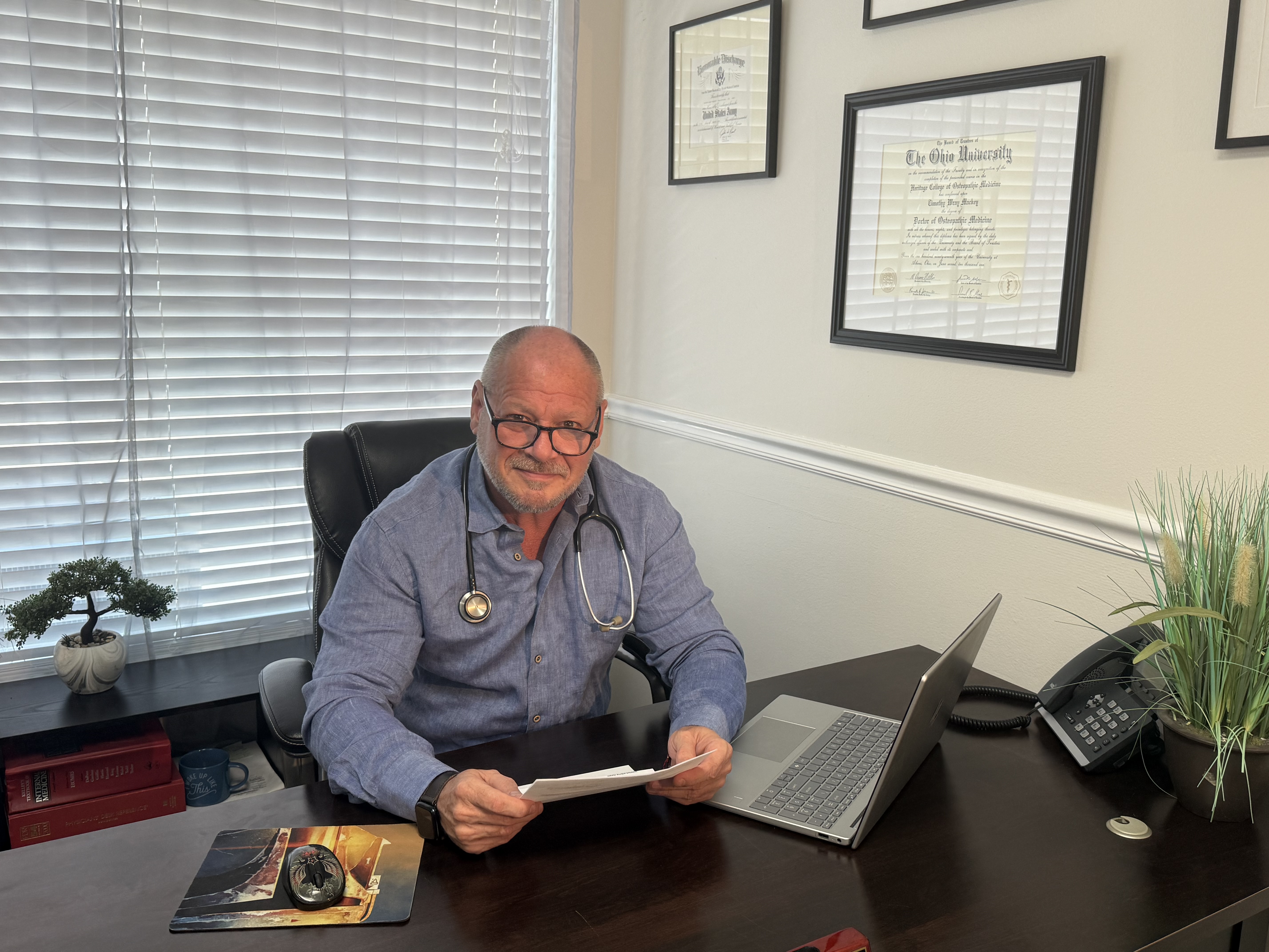 Dr. Timothy Mackey reviewing patient information in his Jupiter office