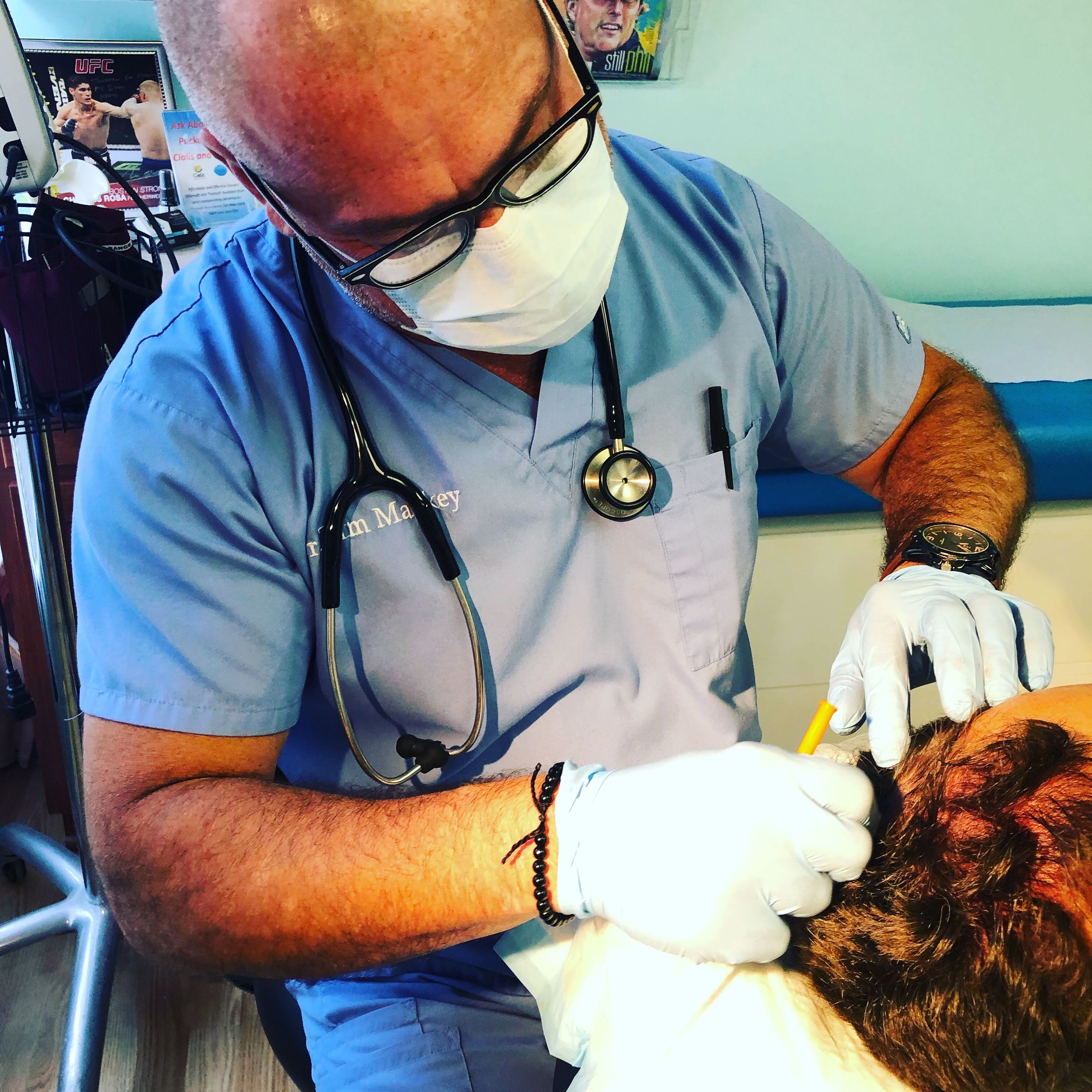 Dr. Timothy Mackey providing hands-on patient care at NovaGenix in Jupiter, Florida