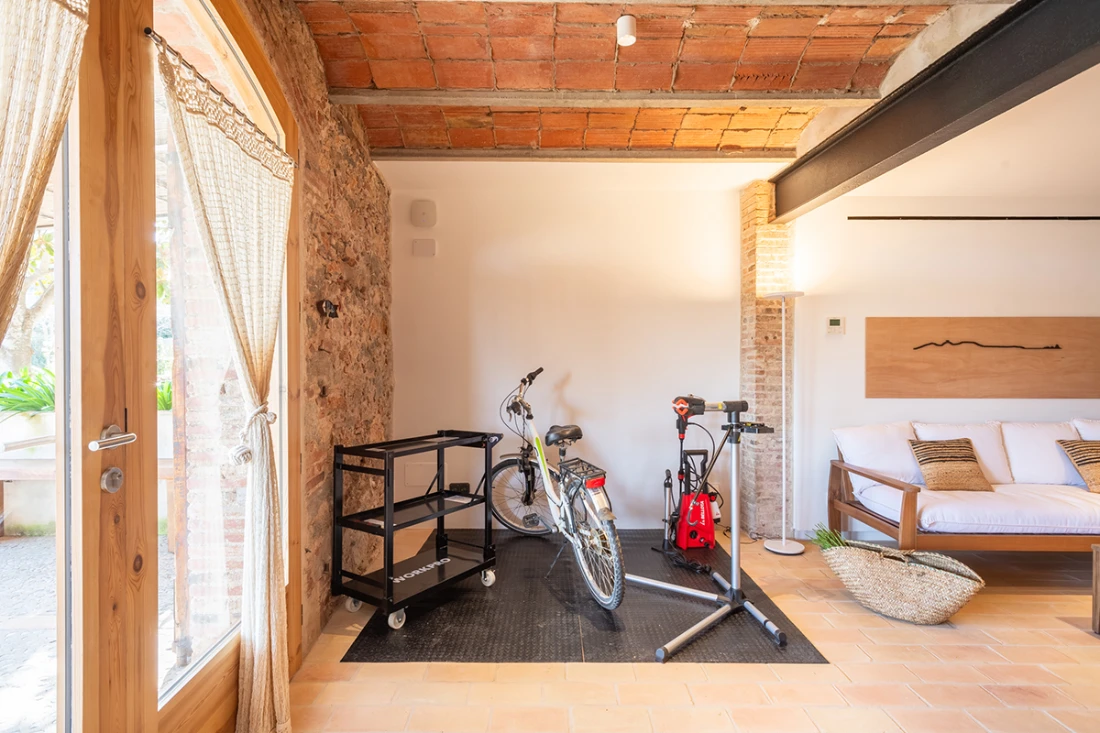 Maintenance and recharging area of bicycles in traditional house Can Moneta Empordà