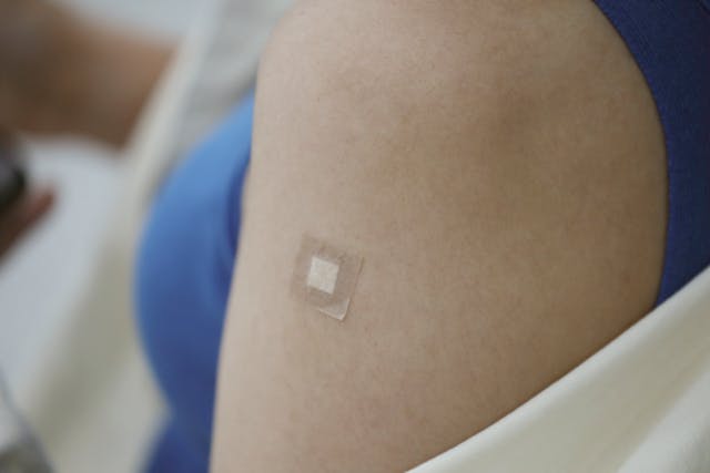 Woman's shoulder with adhesion tape