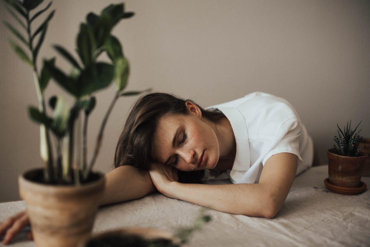 Woman In White Top Laying on the Table