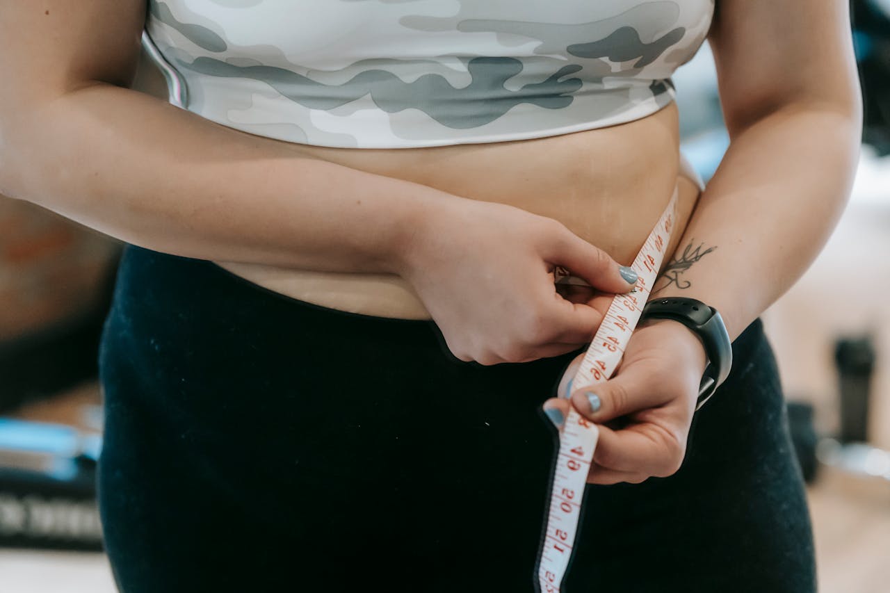 Woman Measuring Her Waist Line