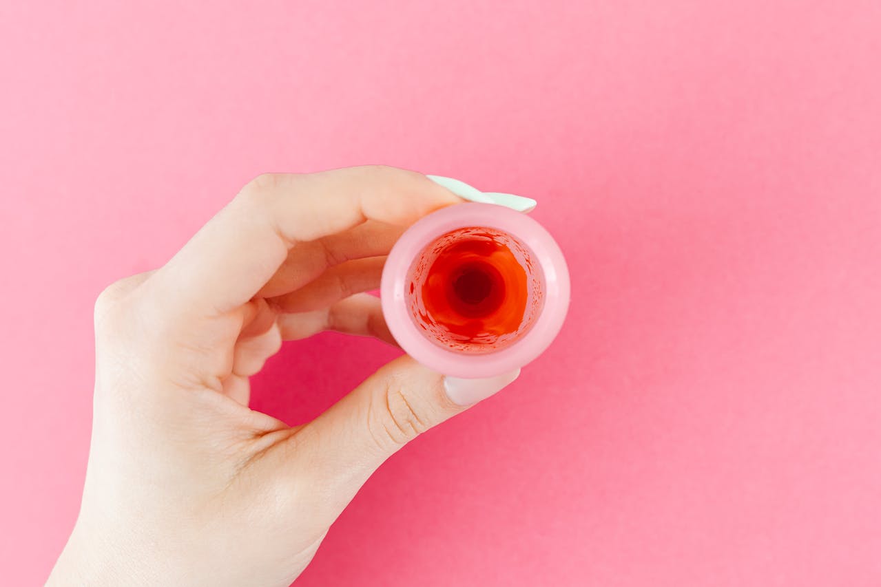 A Menstrual Cup With Blood on a Pink Background