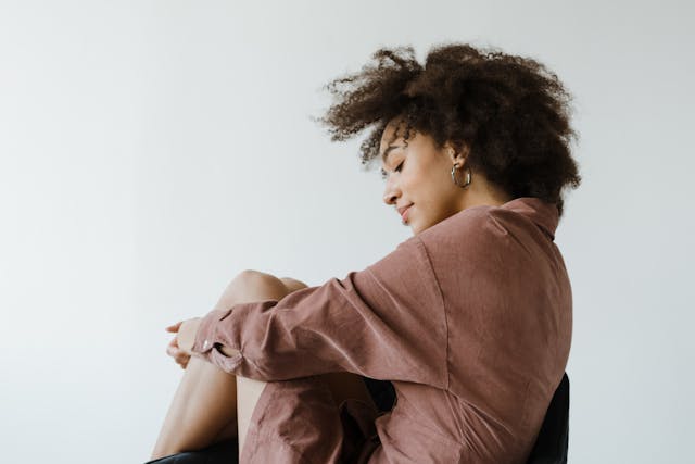 Woman in Brown Long Sleeve Dress Sitting
