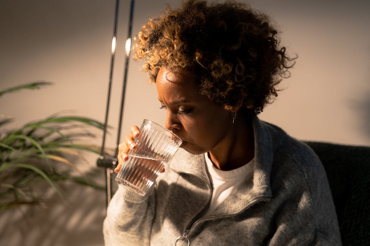 A Woman Drinking a Glass of Water