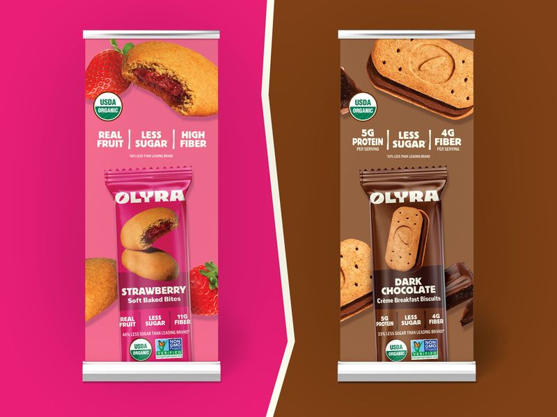 Retractable pop-up banner design for Olyra snack brand, trade show display graphics for Strawberry Soft Baked Bites and Dark Chocolate Crème Breakfast Biscuits used in events and retail promotions