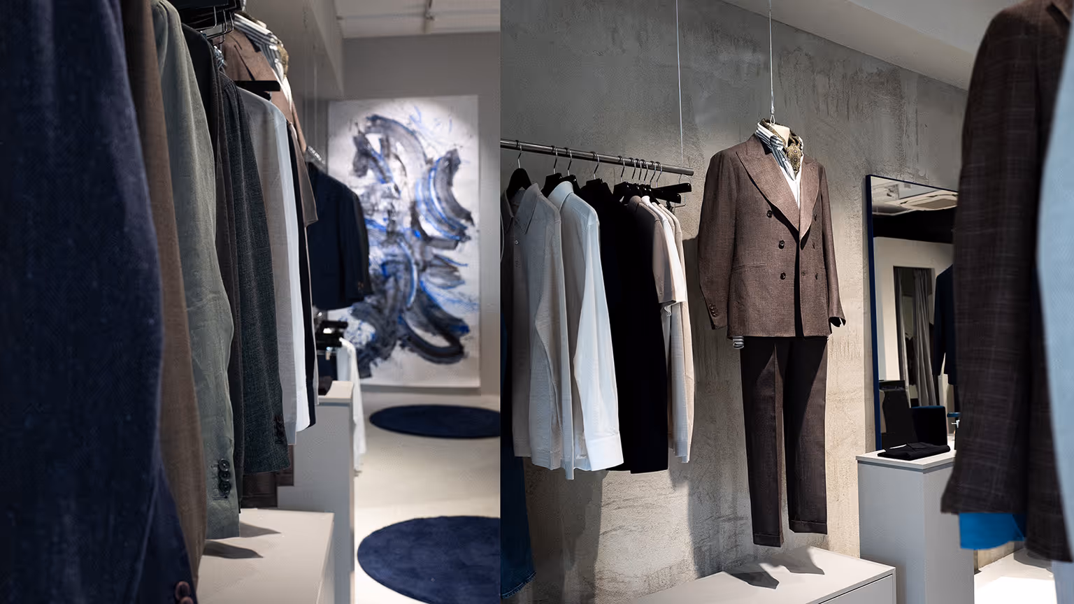 Blick in den HOUSE OF MERCURY Store in Dortmund mit hängenden Maßanzügen und moderner Kunst an der Wand – hochwertige Herrenmode im modernen Interior.