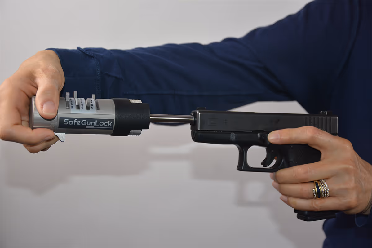 Inserting SafeGunLock into handgun