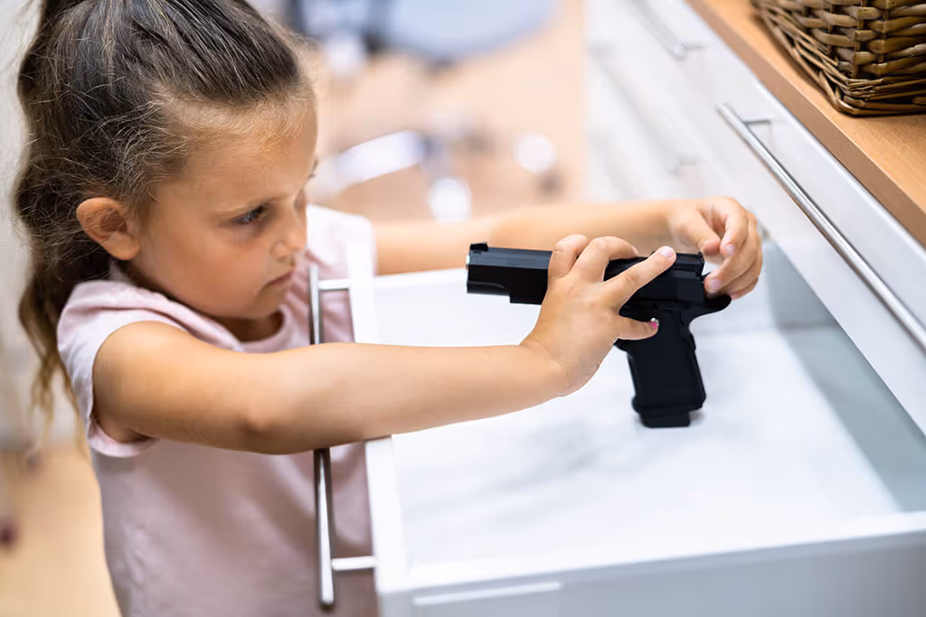 A young girl pointing a handgun at herself