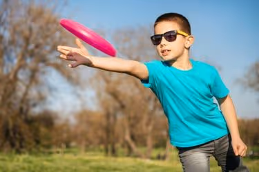 Kid playing with a Frisbee