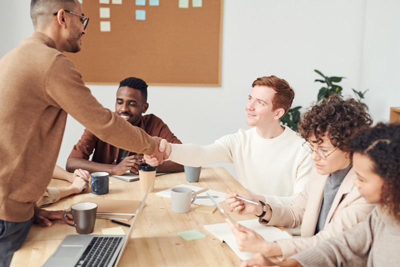 Man shaking hand in team meeting