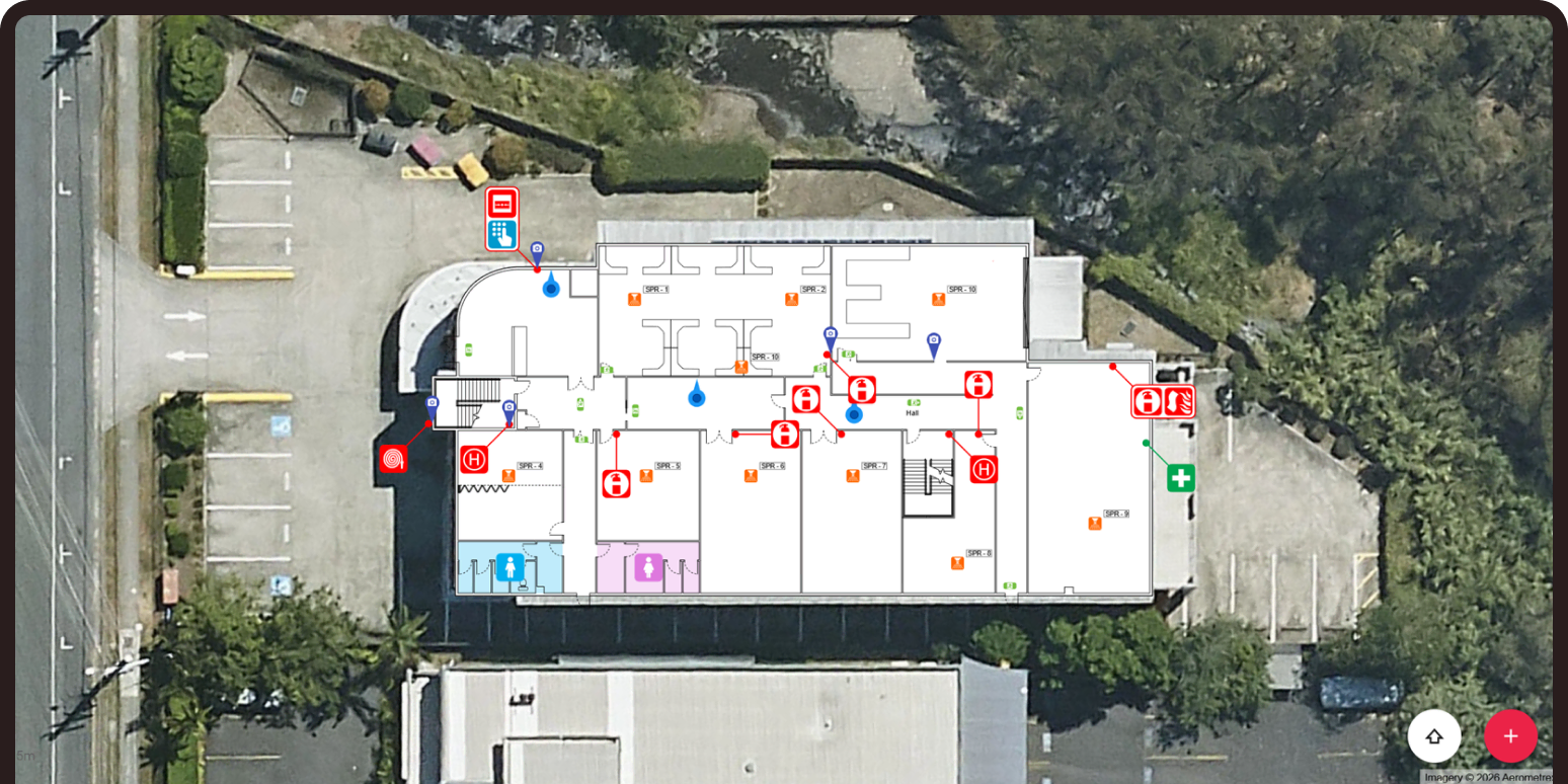 An aerial view of a commercial building and parking lot with a detailed digital floor plan overlaid on top.