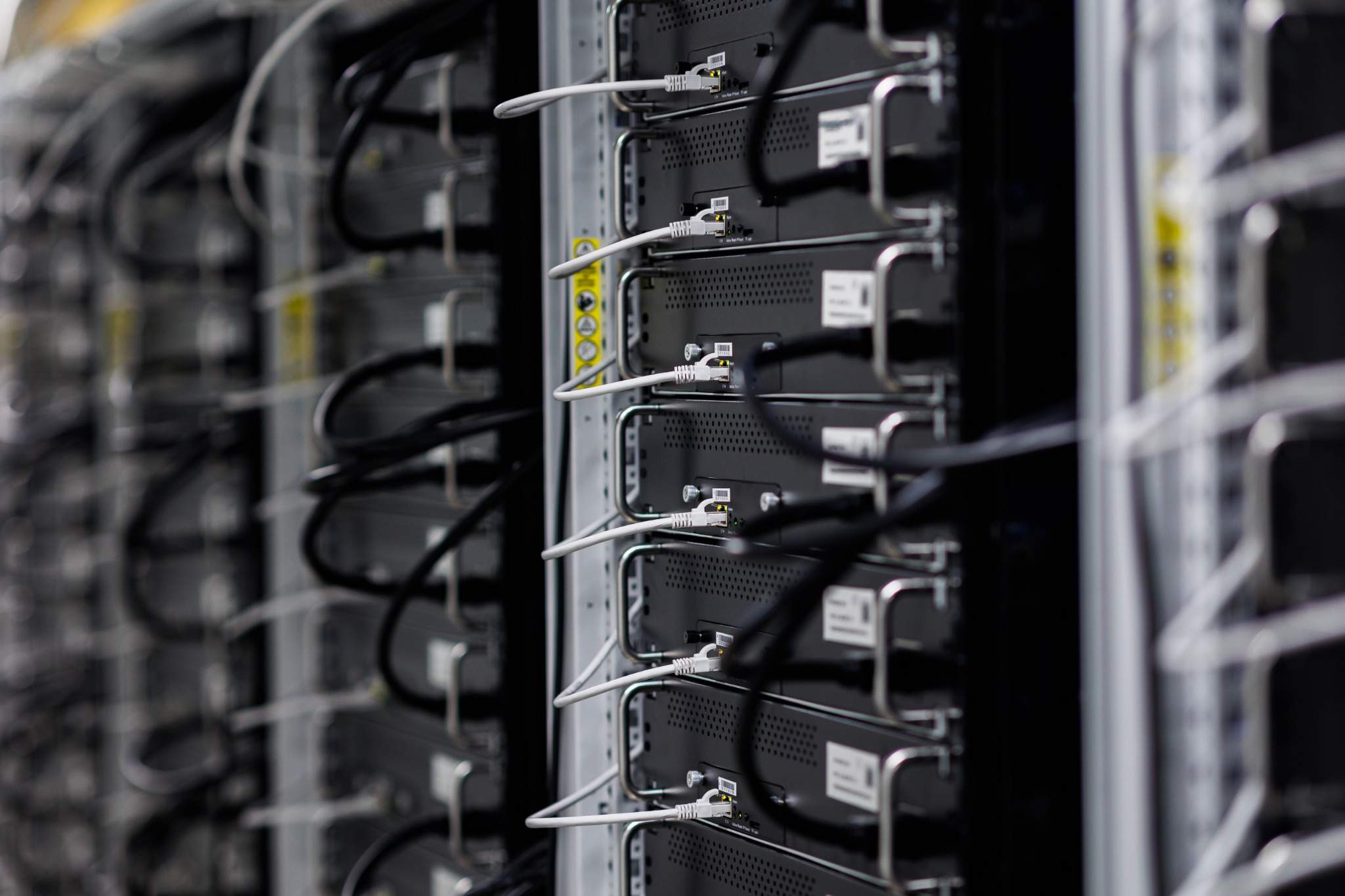 Bitcoin mining hosting with heat recovery in Finland: close-up of a device row in the data center - Cryptohall24