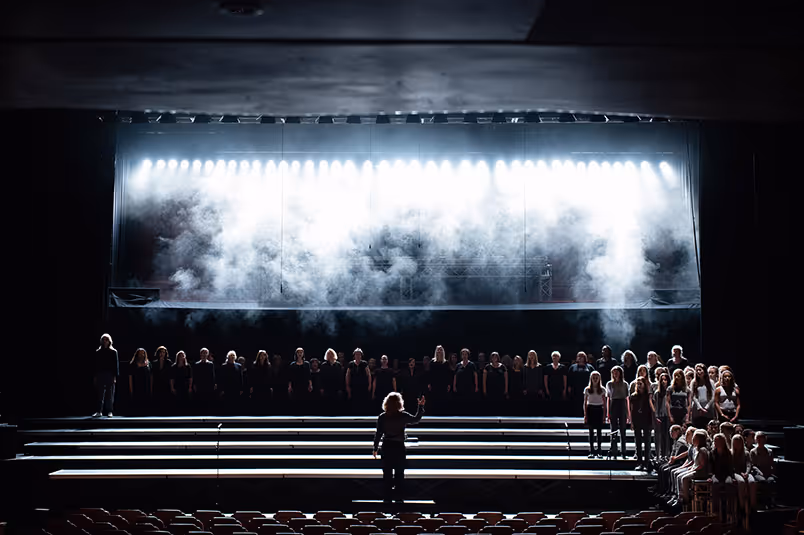 The stage of the Brighton Festival with special effects such as smoke on it and kids in the front