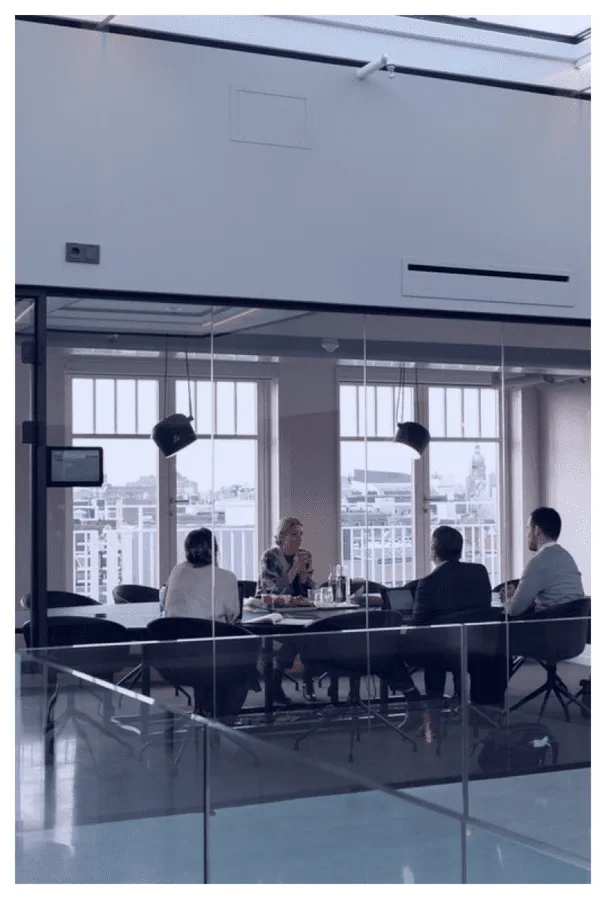 a group of people sitting at a table in a room
