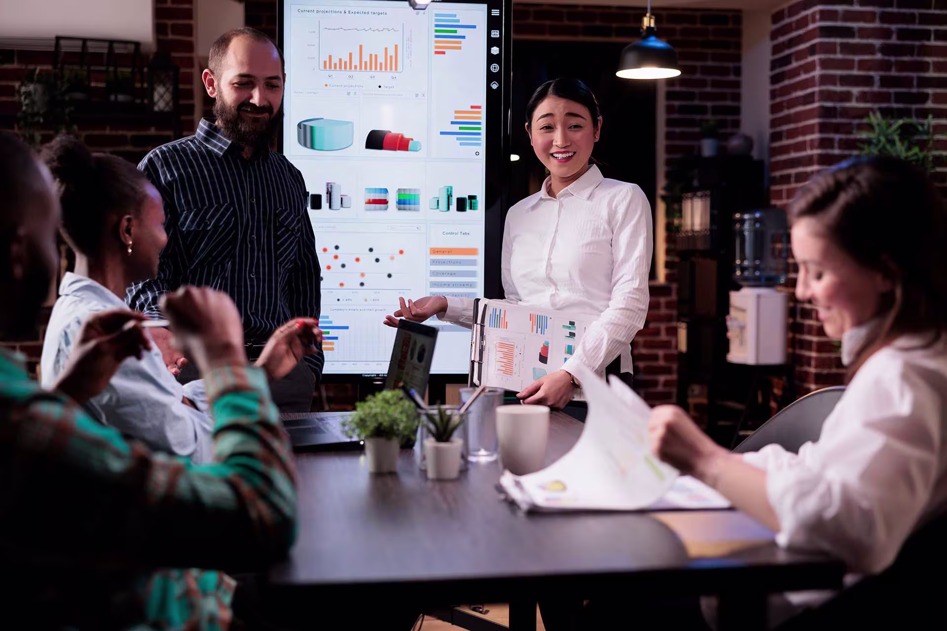 Team assessing CRM implementation strategies with visual data dashboards to evaluate ROI, minimise risk, and determine the right partner vs DIY approach.