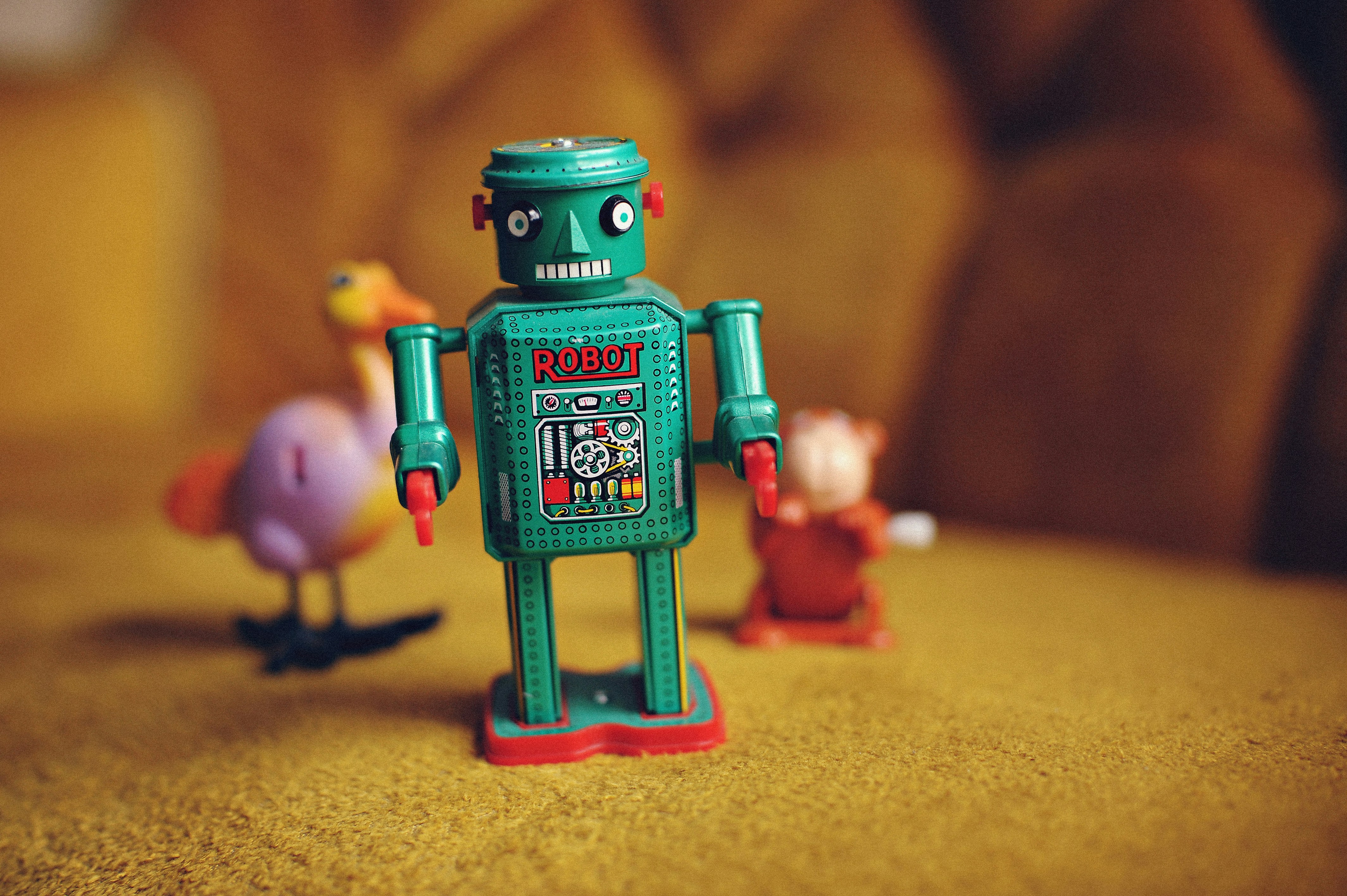 A teal coloured robot, with the word robot written on it.