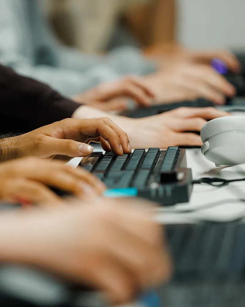 Students working at a music production keyboard and computer setup