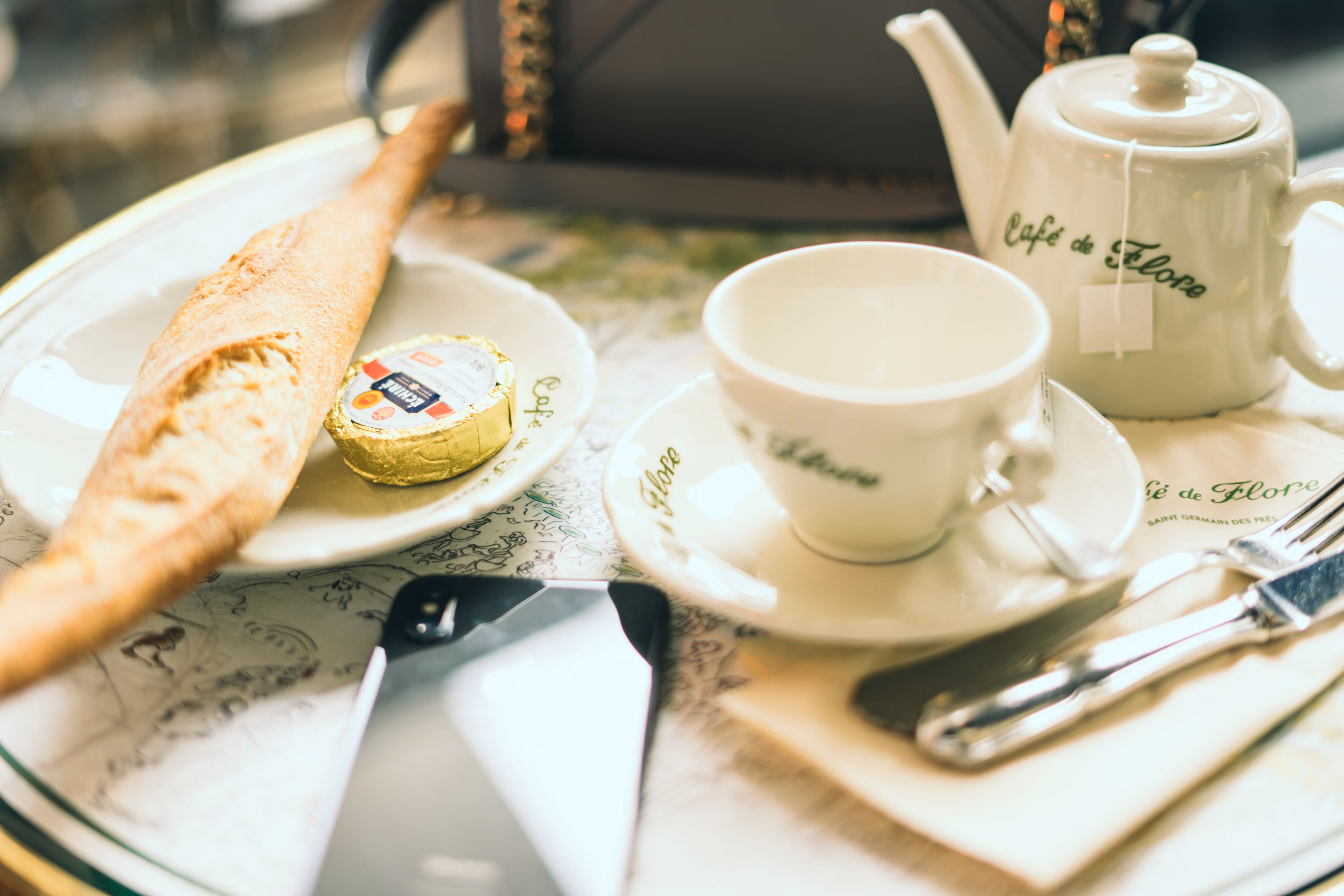 Cafe de Flore Paris tabletop with tea set and baguette