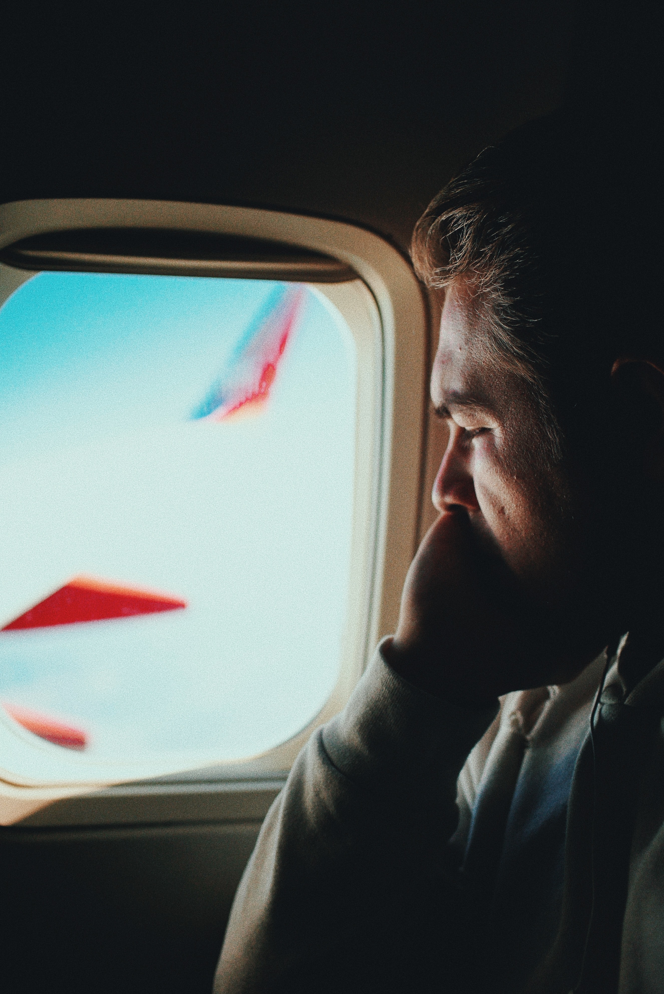 Picture of a man looking out a plane window