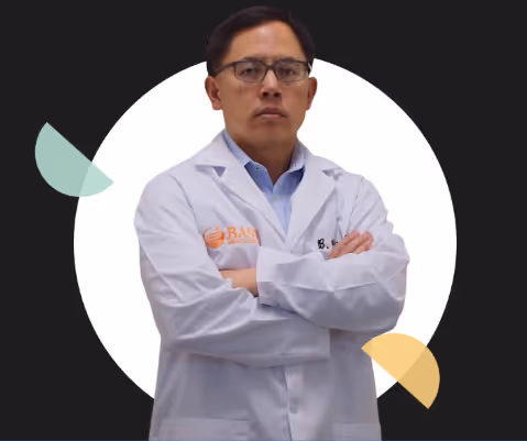 Man in a white lab coat with glasses, arms crossed, standing in front of a white circle on a dark background with abstract shapes.