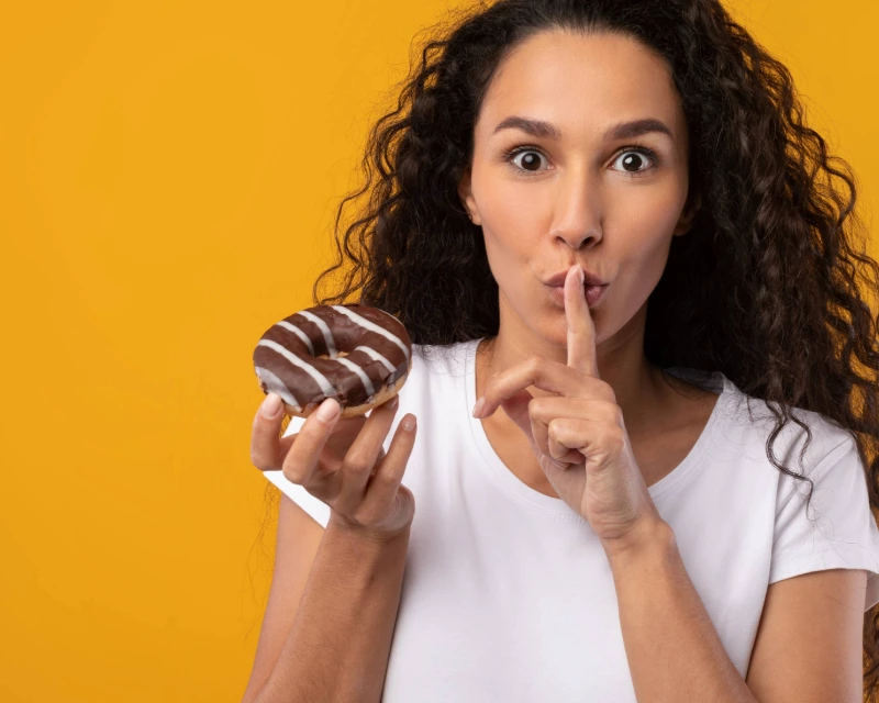 Patient getting ready to eat a donut, symbolizing the rapid return of appetite after stopping GLP-1 medication.
