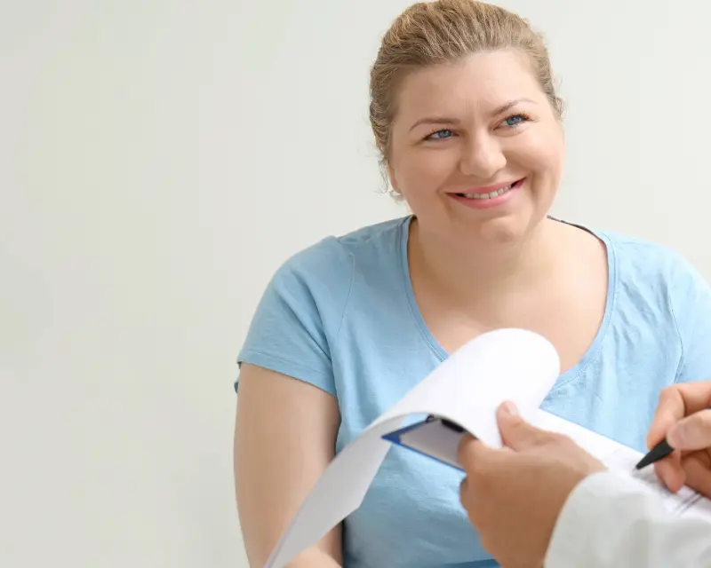 Doctor explaining weight loss surgery versus liposuction to patient.