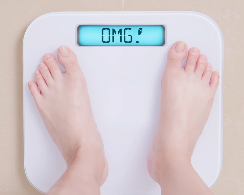 Bathroom scale showing the letters OMG instead of numbers, symbolizing shocking weight regain after stopping semaglutide.