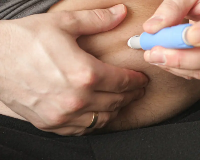Patient injecting themselves with Ozempic despite its serious side effects.