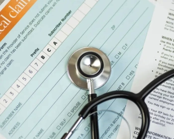 Blank medical insurance claim form with a stethoscope on top.