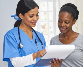 Patient meeting with bariatric care team to review insurance requirements before weight loss surgery.