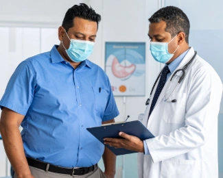 Doctor discussing BMI results and weight-related health risks with a patient